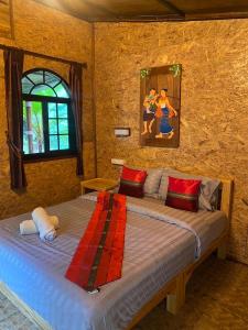 สายน้ำและขุนเขาแม่กำปอง The River & Mountain maekampong في شيانغ ماي: غرفة نوم بها سرير كبير ولوحة فنية على الحائط