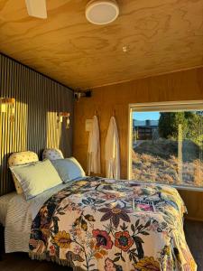 a bedroom with a bed and a large window at Little Hurst House - Escape the Ordinary in Inglewood