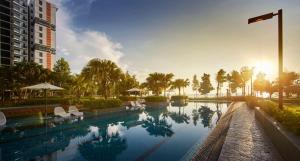 a swimming pool with chairs and a building at Timurbay Residences in Kuantan +14 photos