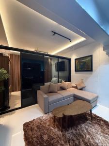 a living room with a couch and a table at Condo unit with balcony in Lapu Lapu Cebu in Mactan Island +5 photos