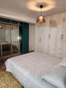 um quarto com uma cama grande e um lustre em Longevid Apartment, Huanchaco An apartment with an ocean view rent for a nigth em Huanchaco