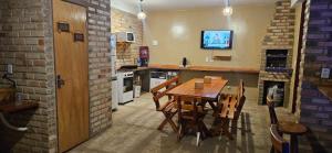 een eetkamer met een houten tafel en stoelen bij Chalé Viçosinha de Açúcar in Viçosa do Ceará