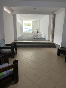 a empty room with a table and chairs in it at Casa da Sol in Arraial do Cabo