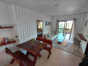 a living room with a table and a couch at House 2 Bedroom with Seaviews near Haad Rin in Koh Phangan
