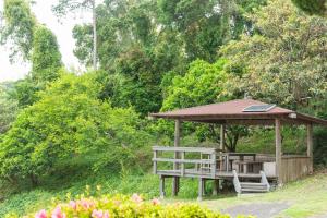 a wooden gazebo with a table and a bench at Shobuzawa Log in Kawazu +25 photos