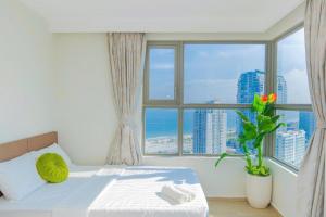 Postel nebo postele na pokoji v ubytování The Song Vung Tau Apartment - Căn Hộ Du Lịch Gần Biển + 49 fotografií