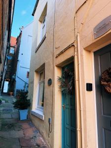 a building with a green door on a street at Rose Cottage in Whitby