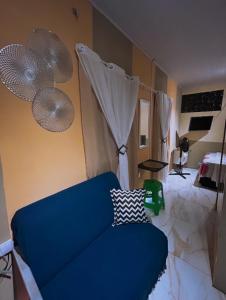 a living room with a blue couch and curtains at Apartamento Reserva Sapiranga in Praia do Forte +9 photos