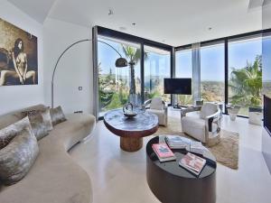 a living room with a couch and a table at Villa in Ibiza with Infinity Pool and Sea Views in Es Cubells