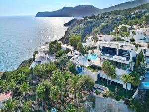 an aerial view of a house next to the water at Villa in Ibiza with Infinity Pool and Sea Views in Es Cubells