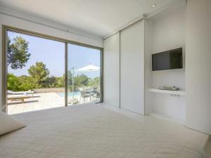 a bedroom with a large bed and a large window at Villa in Ibiza near Talamanca Beach in Talamanca +28 photos