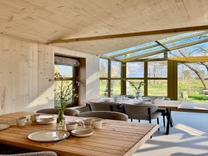 a dining room with tables and chairs and windows at Group accommodation for 36 guests in Scherpenzeel