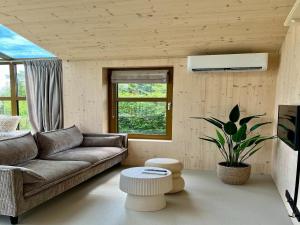 a living room with a couch and a table at Group accommodation for 36 guests in Scherpenzeel