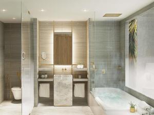 a bathroom with a tub and a toilet at Rixos Obhur Jeddah Resort & Villas - All-Inclusive in Jeddah