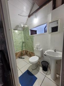 a bathroom with a toilet and a sink at Chalé de Trindade in Trindade +27 photos