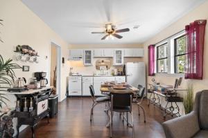a kitchen and living room with a table and chairs at The Riverside Cottage in Dardanelle