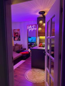 um quarto roxo com uma sala de estar com um sofá em The Hot Spot em Kosovo Polje