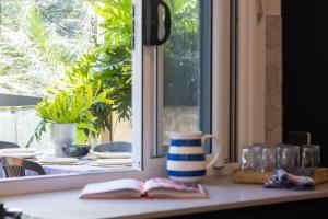 a table with two books on a window sill at Bluegum Beach Stay in Narrawallee +20 photos