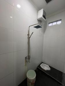 a small bathroom with a toilet and a shower at Villa Murah Joglo Sariwangi in Cihanjuang 1 +29 photos
