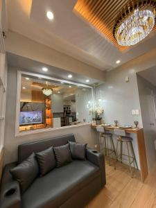 a living room with a couch and a bar at Tagaytay Wind Residences in Tagaytay