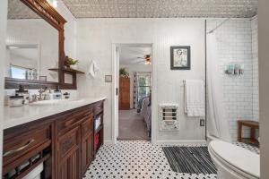 a bathroom with a sink and a toilet and a shower at The Riverside Cottage in Dardanelle +21 photos