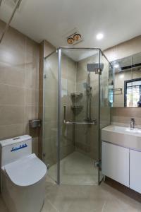 a bathroom with a shower and a toilet and a sink at Caelistay in Hanoi +52 photos