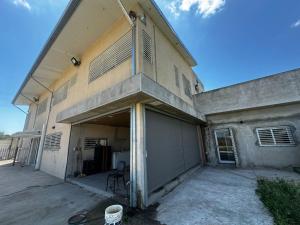 a large building with a garage with a door at Casa quinta a minutos de La Plata in Berisso