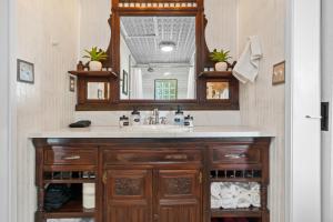 a bathroom with a sink and a mirror at The 1950s Retro Riverside Cottage in Dardanelle +60 photos