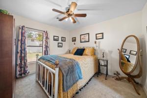 a bedroom with a bed and a ceiling fan at The Riverside Cottage in Dardanelle