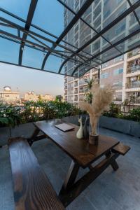 a wooden table on a balcony with a view of a city at Caelistay in Hanoi