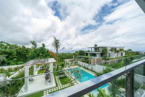 a view from the balcony of a house with a swimming pool at Gandum Villa Complex - Luxury Boutique Stay Uluwatu in Uluwatu