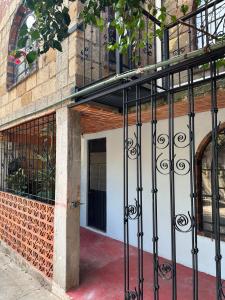 a building with a black wrought iron gate at Casa Rústica del pedregal in Mexico City