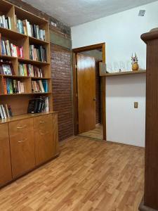 an empty room with a book shelf and a door at Casa Rústica del pedregal in Mexico City