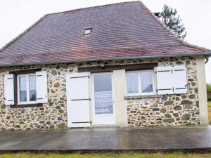 a stone house with white doors and a brown roof at Maison indépendante en pleine nature dans la Vallée de l'Auvézère - FR-1-616-140 in Saint-Mesmin