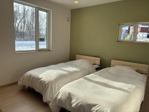 Postel nebo postele na pokoji v ubytování Niseko Izumikyo