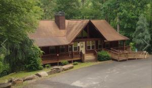 a large wooden house with a porch and a roof at North Ga Hideaway in Ranger