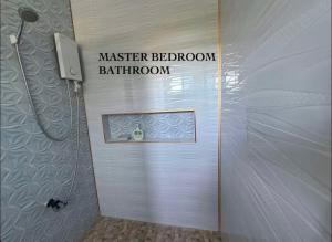 a bathroom with a shower and a sign that reads master bedroom bathroom bathroom at Blue Horizon in Bantayan Island +28 photos