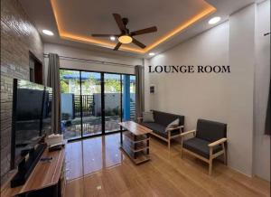 a lobby with a lounge room with a ceiling fan at Blue Horizon in Bantayan Island