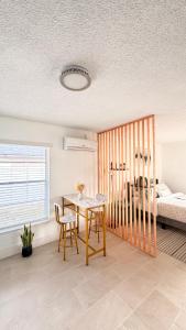 Hermoso apartaestudio en Orlando في أورلاندو: غرفة طعام مع طاولة وسرير