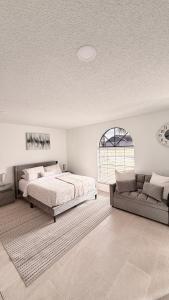 Hermoso apartaestudio en Orlando في أورلاندو: غرفة نوم بها سرير وأريكة