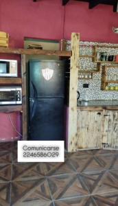 a refrigerator in a kitchen next to a counter at Costero in Santa Teresita