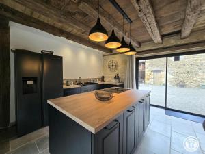 a kitchen with a wooden counter top in a room at Maison en pierres au cœur du Périgord, 10 personnes, charme authentique - FR-1-616-508 in LʼAir