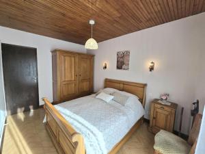a bedroom with a large bed and a wooden ceiling at Maison de campagne confortable en Dordogne - FR-1-616-521 in Lala