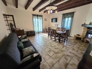 a living room with a couch and a table at Maison de campagne confortable en Dordogne - FR-1-616-521 in Lala