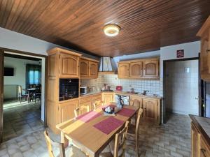 a kitchen with wooden cabinets and a wooden table at Maison de campagne confortable en Dordogne - FR-1-616-521 in Lala +10 photos