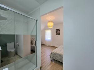 a bathroom with a glass shower and a bedroom at Charmante maison avec piscine chauffée privée au cœur du Périgord Noir - FR-1-616-530 in Prats-de-Carlux