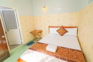 a bed in a small room with a bed sidx sidx sidx at Như Quỳnh Hotel HCM in Ho Chi Minh City