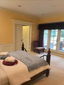 a bedroom with a large bed and a chair at Kerrisdale cozy house in Vancouver +15 photos
