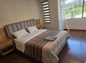 En eller flere senge i et værelse på Hospedaje cerca del aeropuerto