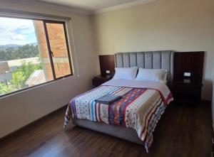 En eller flere senge i et værelse på Hospedaje cerca del aeropuerto